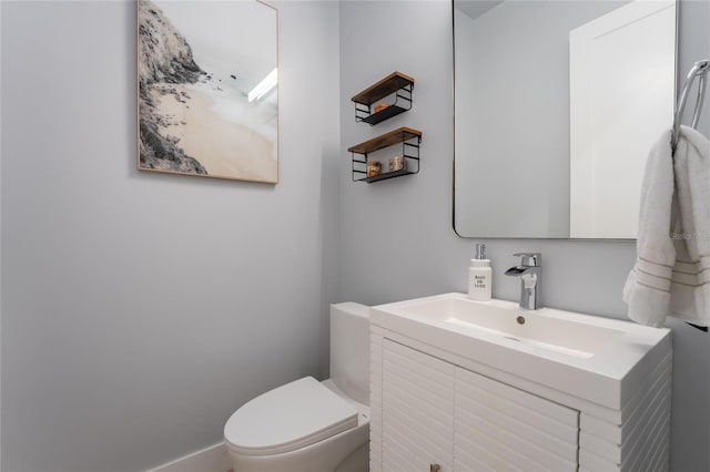 bathroom featuring toilet and vanity