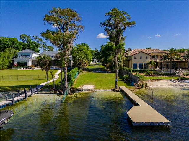 dock area featuring a water view and a lawn