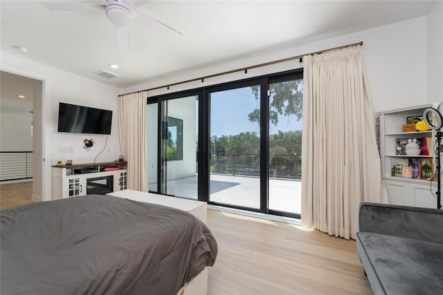 bedroom featuring light hardwood / wood-style flooring, ceiling fan, and access to exterior