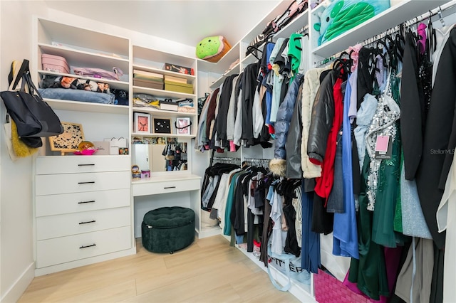 spacious closet with light hardwood / wood-style floors