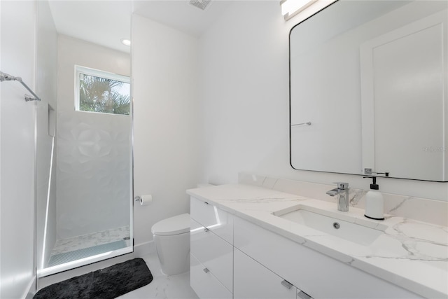 bathroom featuring toilet, a shower, vanity, and tile floors