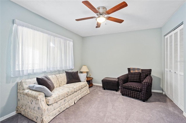 carpeted living room featuring ceiling fan