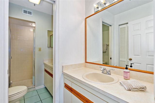 bathroom with toilet, vanity, an enclosed shower, and tile floors