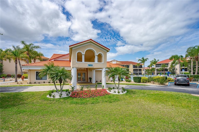 mediterranean / spanish-style house featuring a front lawn