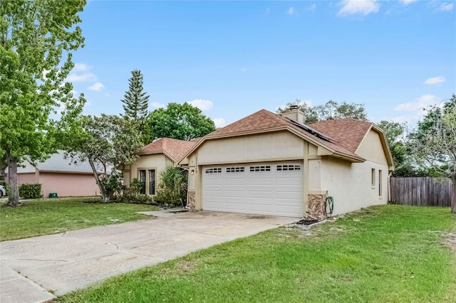 view of front of home with a garage and a front lawn