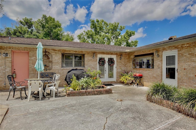 view of front of house with french doors and a patio