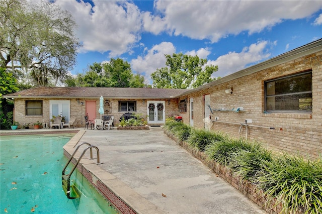 rear view of property featuring a patio area and french doors