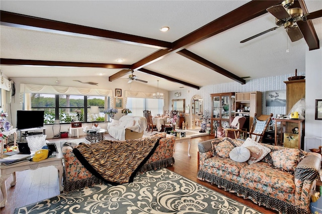 living room with wood-type flooring, lofted ceiling with beams, and ceiling fan