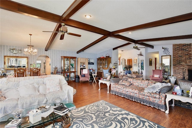 living room with vaulted ceiling with beams, ceiling fan with notable chandelier, and dark wood-type flooring