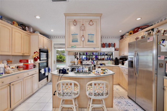 kitchen with light tile floors, a kitchen island, a textured ceiling, oven, and stainless steel fridge