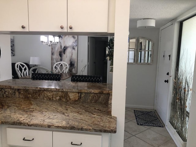 bathroom featuring tile floors and a textured ceiling