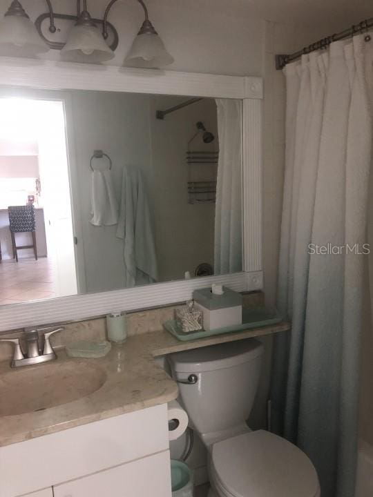 bathroom featuring oversized vanity and toilet