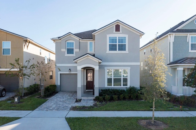 view of property featuring a garage and a front yard