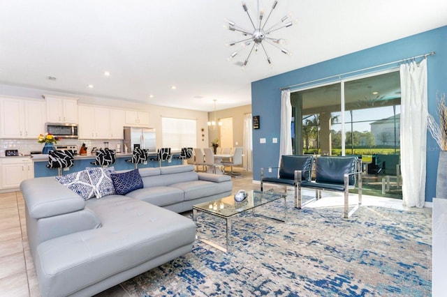 living room featuring a notable chandelier and light tile floors