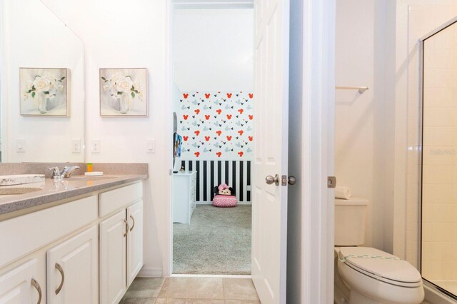 bathroom featuring an enclosed shower, toilet, tile floors, and vanity