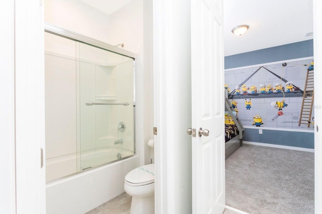 bathroom featuring toilet and shower / bath combination with glass door