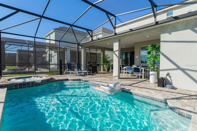 view of swimming pool featuring a patio, an in ground hot tub, and glass enclosure