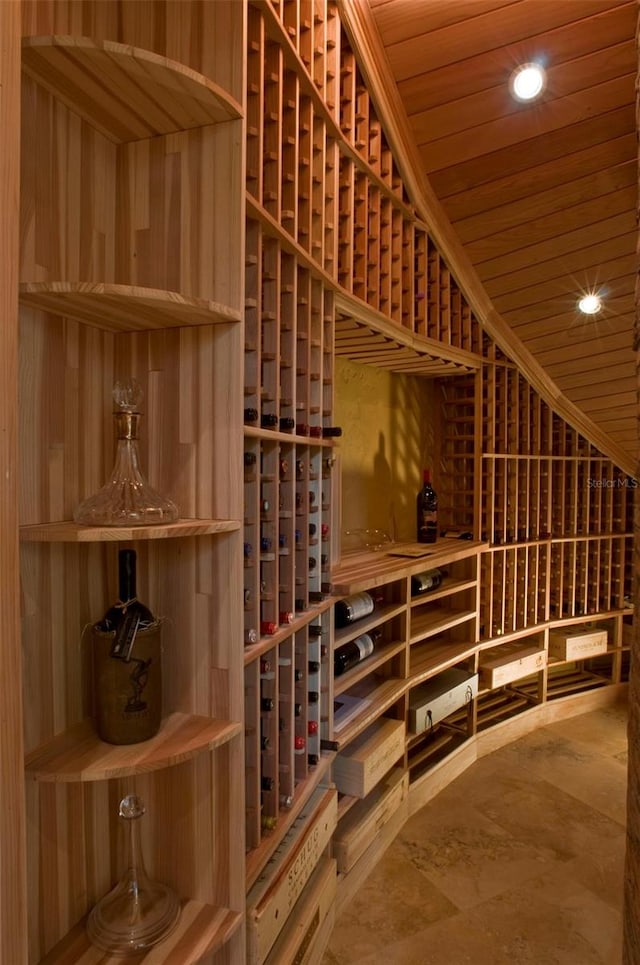 wine cellar featuring wood ceiling and wood walls