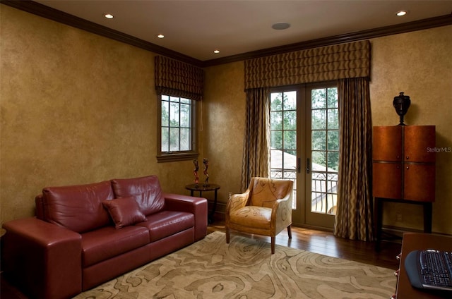 sitting room featuring french doors, plenty of natural light, wood-type flooring, and ornamental molding