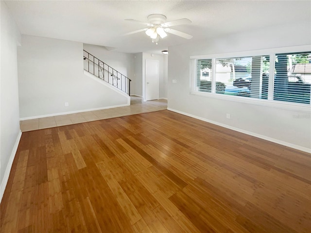 tiled empty room with ceiling fan