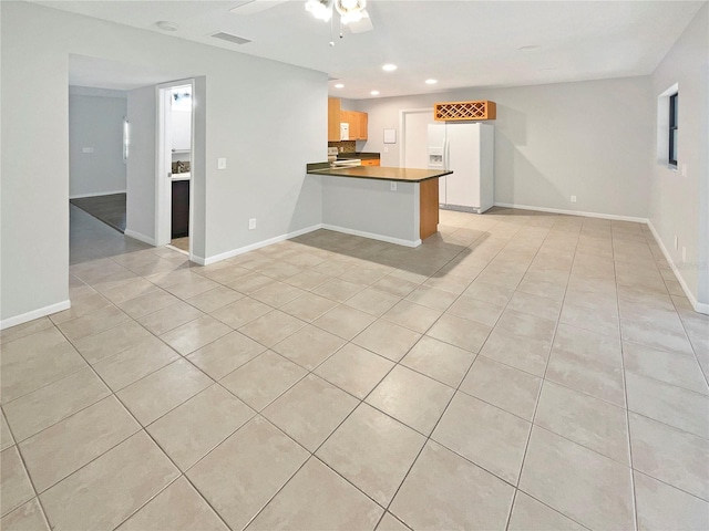 interior space with ceiling fan and light tile floors