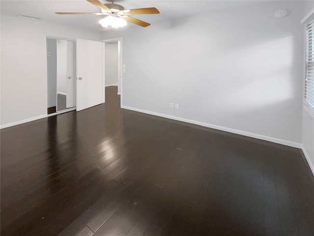 unfurnished bedroom featuring dark hardwood / wood-style flooring and ceiling fan