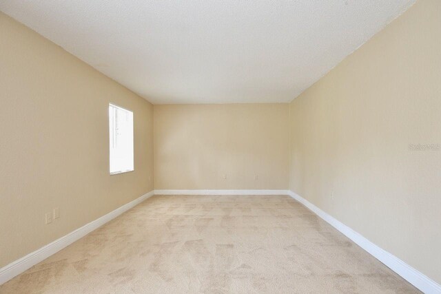 unfurnished room with carpet flooring