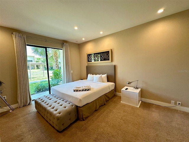 carpeted bedroom with multiple windows and access to outside