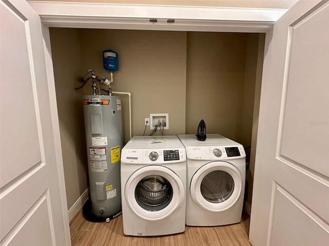 washroom with water heater, separate washer and dryer, and hookup for a washing machine