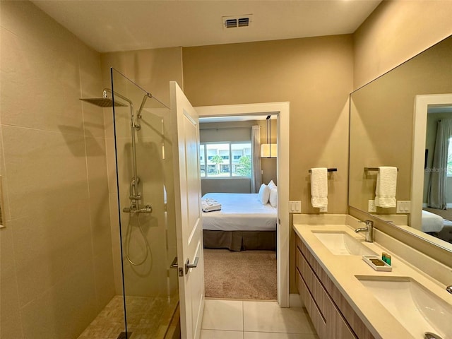 bathroom with double sink vanity, tile floors, and a shower with shower door