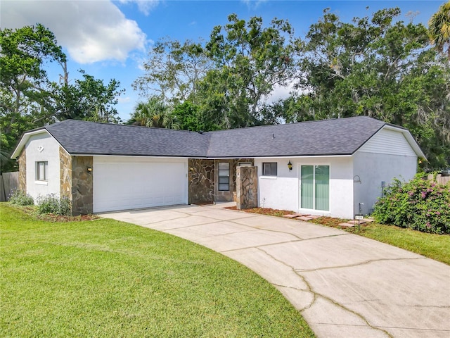 single story home featuring a garage and a front lawn