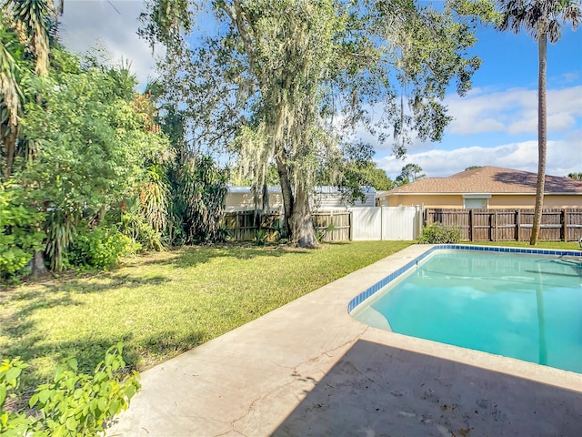 view of swimming pool with a patio, a lawn, a fenced backyard, and a fenced in pool