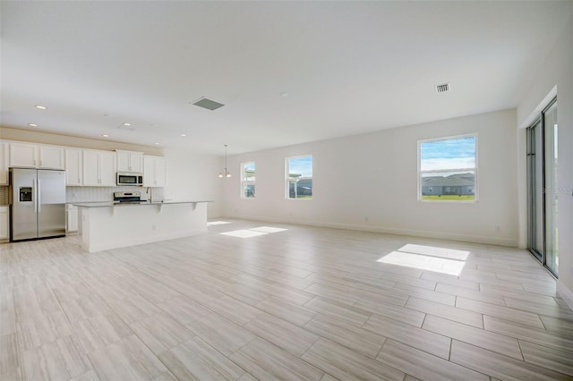 unfurnished living room featuring a healthy amount of sunlight