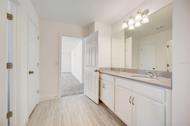 bathroom featuring tile flooring, vanity with extensive cabinet space, and dual sinks