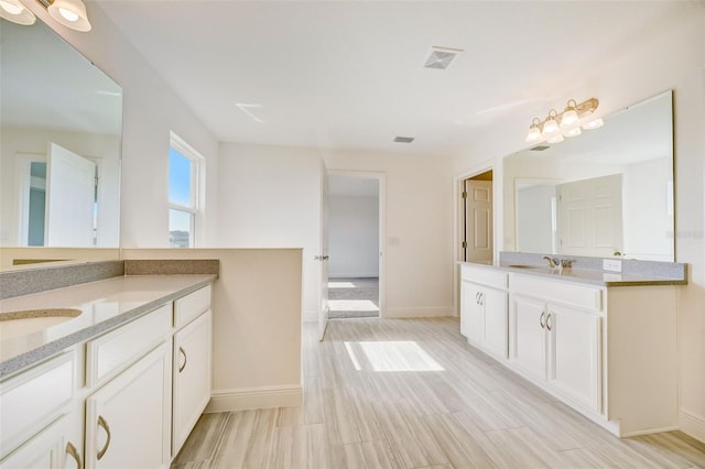 bathroom with tile floors and dual vanity