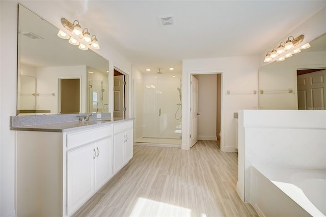 bathroom featuring tile flooring, vanity, and separate shower and tub