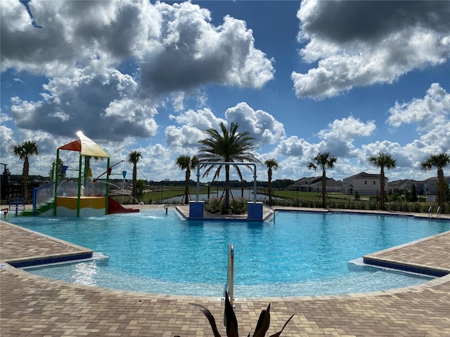 view of pool with a playground