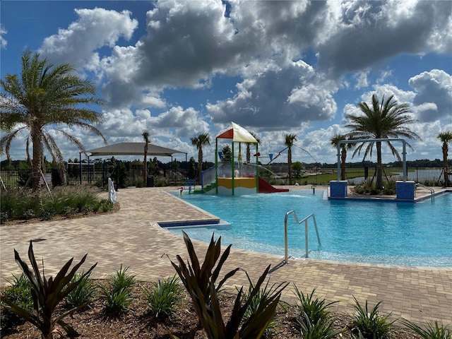 view of swimming pool with a playground