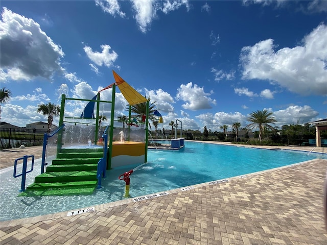 view of pool featuring a playground