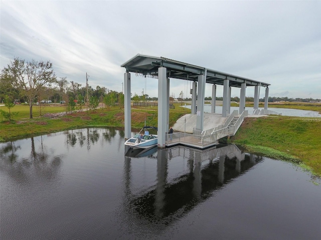 view of dock featuring a yard and a water view