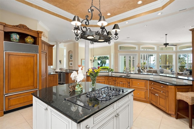 kitchen with black gas cooktop, white cabinetry, a kitchen island, and paneled built in refrigerator