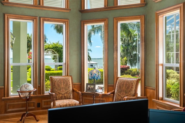 sunroom featuring a healthy amount of sunlight and a water view