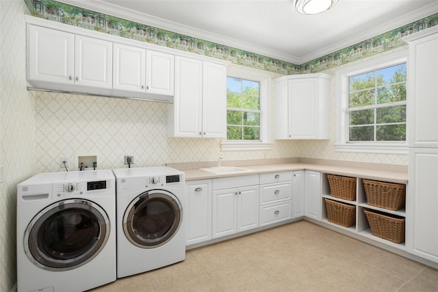 laundry room with light tile flooring, a wealth of natural light, separate washer and dryer, and sink