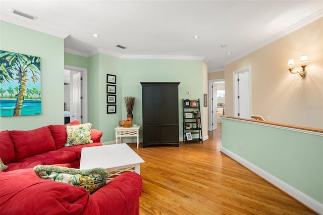 living room featuring crown molding and light wood-type flooring