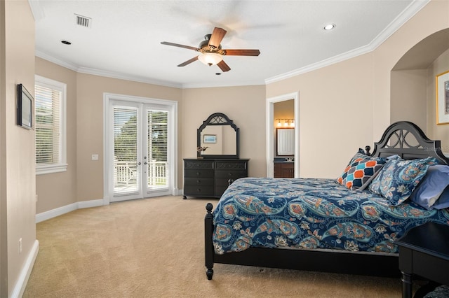 carpeted bedroom featuring ceiling fan, ensuite bath, crown molding, access to outside, and french doors