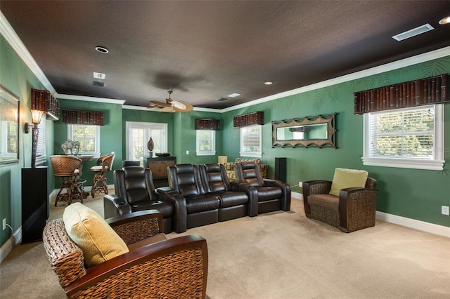 carpeted living room featuring ornamental molding, ceiling fan, and a textured ceiling