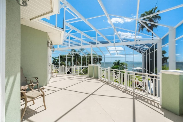 unfurnished sunroom with a water view