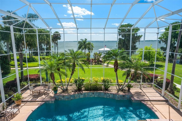 view of pool featuring a water view, a patio area, a lanai, and a lawn