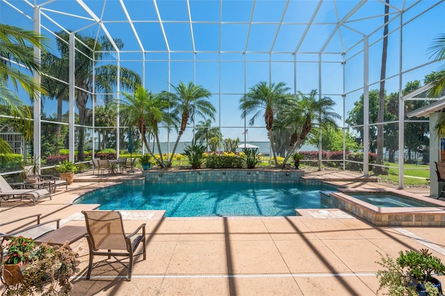 view of swimming pool featuring a patio, glass enclosure, and an in ground hot tub