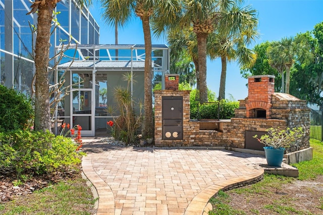 view of gate with a patio area and exterior fireplace